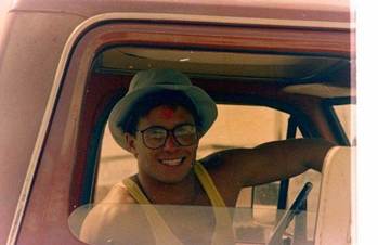 A person in a hat and glasses Description automatically generated