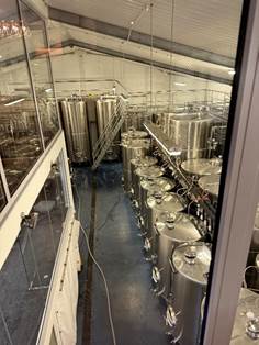 A room with several large silver tanks AI-generated content may be incorrect.