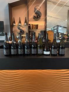 A group of bottles of wine on a shelf AI-generated content may be incorrect.