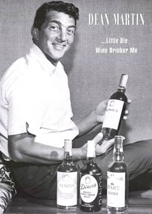 A person holding a bottle of wine<br />
<br />
Description automatically generated